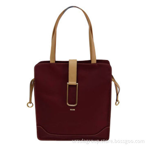 Big shopper bag with one middle zip compartment and one big decoration buckle on front tab